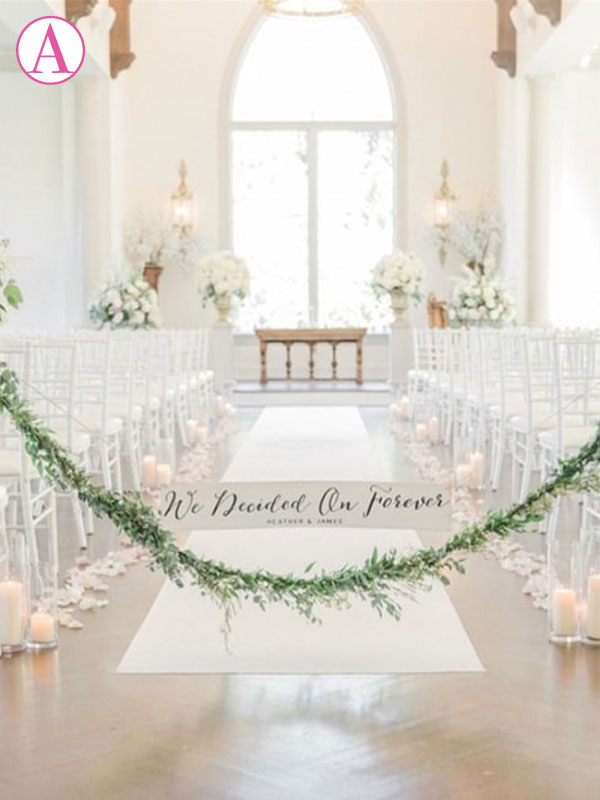 Most popular placement for wedding aisle runner is flush with the top row of chairs.