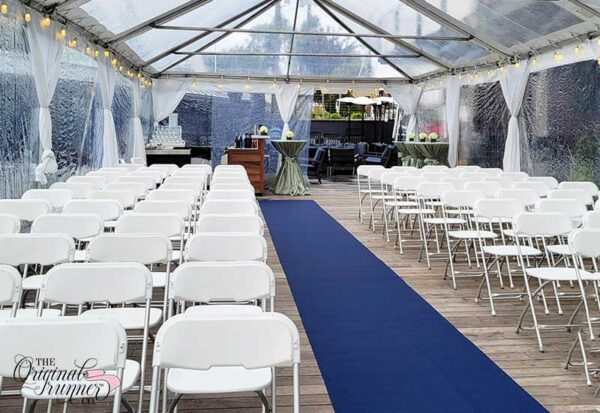 Tent Wedding with navy blue aisle runner. Wooden deck.