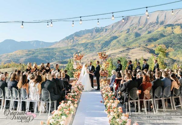 Credits: Aisle runner: The Original Runner Company @originalrunners (IG) Planning: K2 Event Co. @k2eventco (IG) Venue: The Peaks Resort and Spa @PeaksResortSpa (IG) Photography: Nate Puhr - photo & cinema @natepuhr (IG) Florals: Dahlia Floral Design @dahliafloraldesign (IG) Videography: Jason and Daris Photocinema Hair: Moxie Loft, Makeup: Haley Skye Makeup Ceremony + Cocktail Music: Telluride Strings Reception Music: Diamond Empire Cake + Dessert Bar: Jacque's Sweet Treats Photobooth: Griz Entertainment Rentals, Linens, Decor: Colorado Party Rental Candles: K2 Event Co Lighting + Disco Ball Installation: Night Circus Lighting Oxygen Bar: Oxygen Delivers Flash Mob: Telluride Theatre Invitations and Signage: DFW Wood Creations